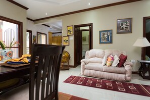 City Apartment, 2 Bedrooms | Living area | 50-inch flat-screen TV with cable channels, TV, DVD player - New Kingston Guest Apartment at Inglaterra III (Kingston)