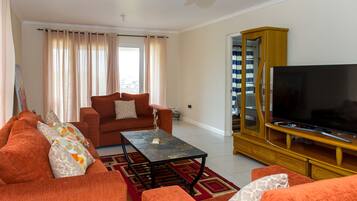 Luxury Apartment, 2 Bedrooms | Living room | 50-inch flat-screen TV with cable channels, TV, DVD player