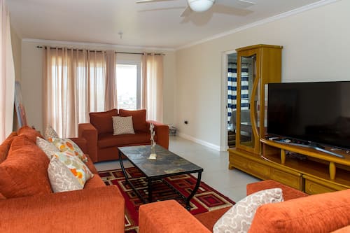 Luxury Apartment, 2 Bedrooms | Living room | 50-inch flat-screen TV with cable channels, TV, DVD player