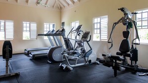 A gym with treadmills, elliptical machines, and weightlifting equipment. - Ocho Rios Beach House at Dax Hall (Ocho Rios)