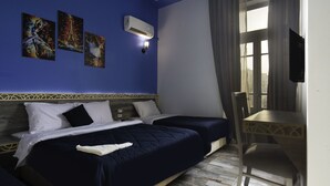 A hotel room with two beds, a desk, and a window with curtains. - Australian Deluxe Hostel (Cairo)
