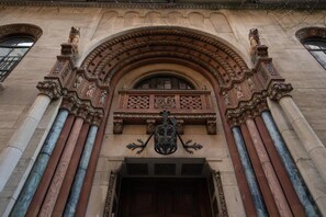 An ornate building entrance with a detailed archway and a coat of arms above the door. - YMCA West Side (New York)