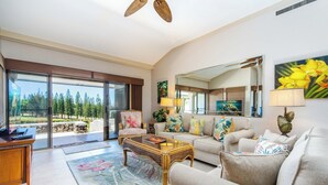 A spacious living room with a large window, a sofa, a coffee table, and a television. - The Most Gorgeous OV Villa in Kapalua Sleeps 6 (Kapalua)