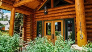 A log cabin with a wooden exterior, a covered porch, and a number '19' sign. - Sundance Grand Overlook (Telluride)