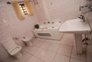 Suite senior, 1 cama matrimonial | Baño | Tina profunda, regadera tipo lluvia, amenidades de baño gratuitas 
