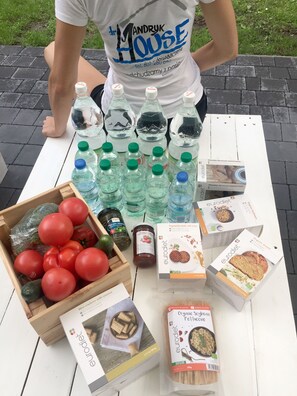 A table with various food items including bottled water, jars of preserves, and boxes of Eurodiet products.