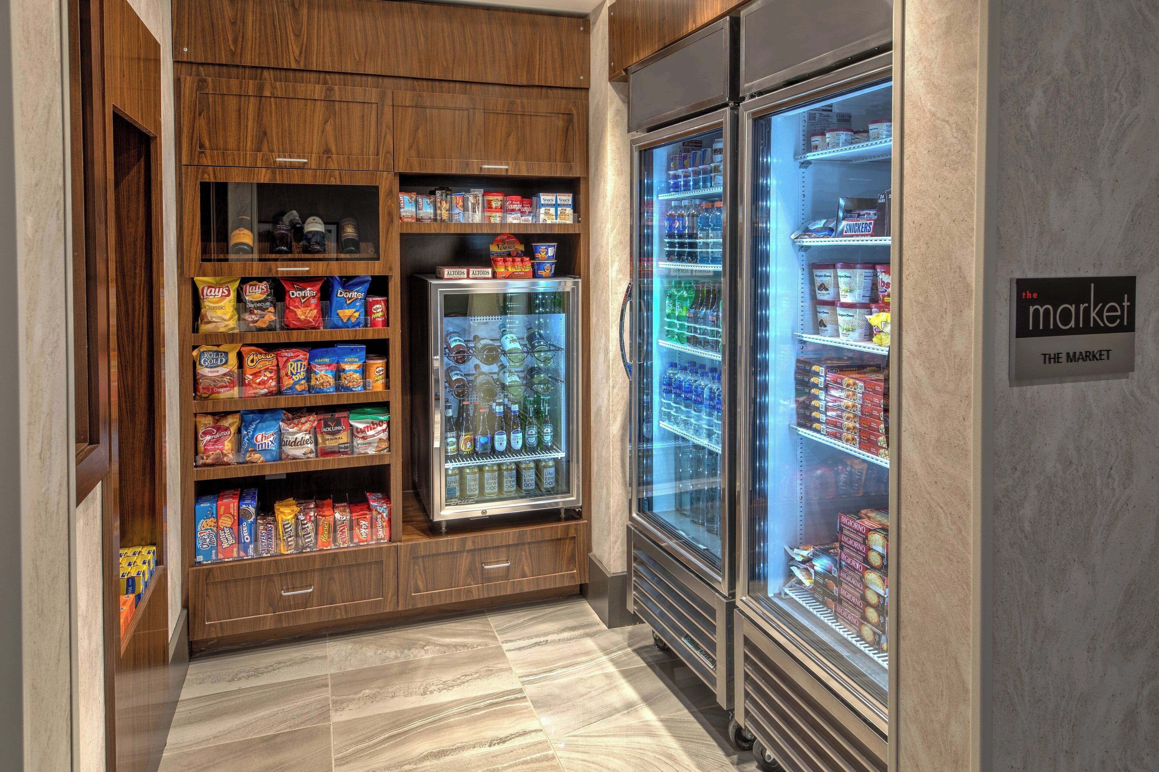 A snack display with chips and a refrigerated section with bottled water and soda.