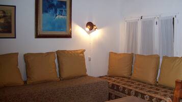 Basic House, Multiple Beds | Living room | Flat-screen TV