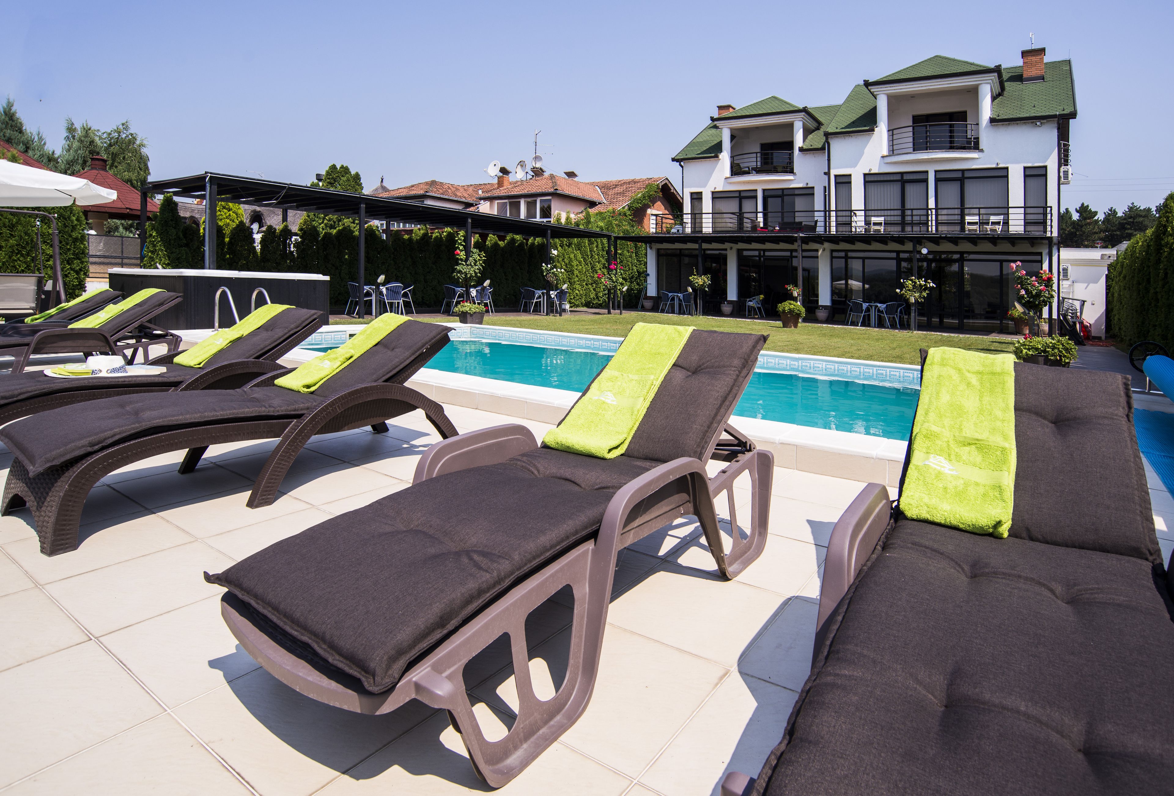 A poolside area with lounge chairs and a pool.