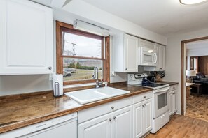Fridge, microwave, coffee/tea maker, cookware/dishes/utensils