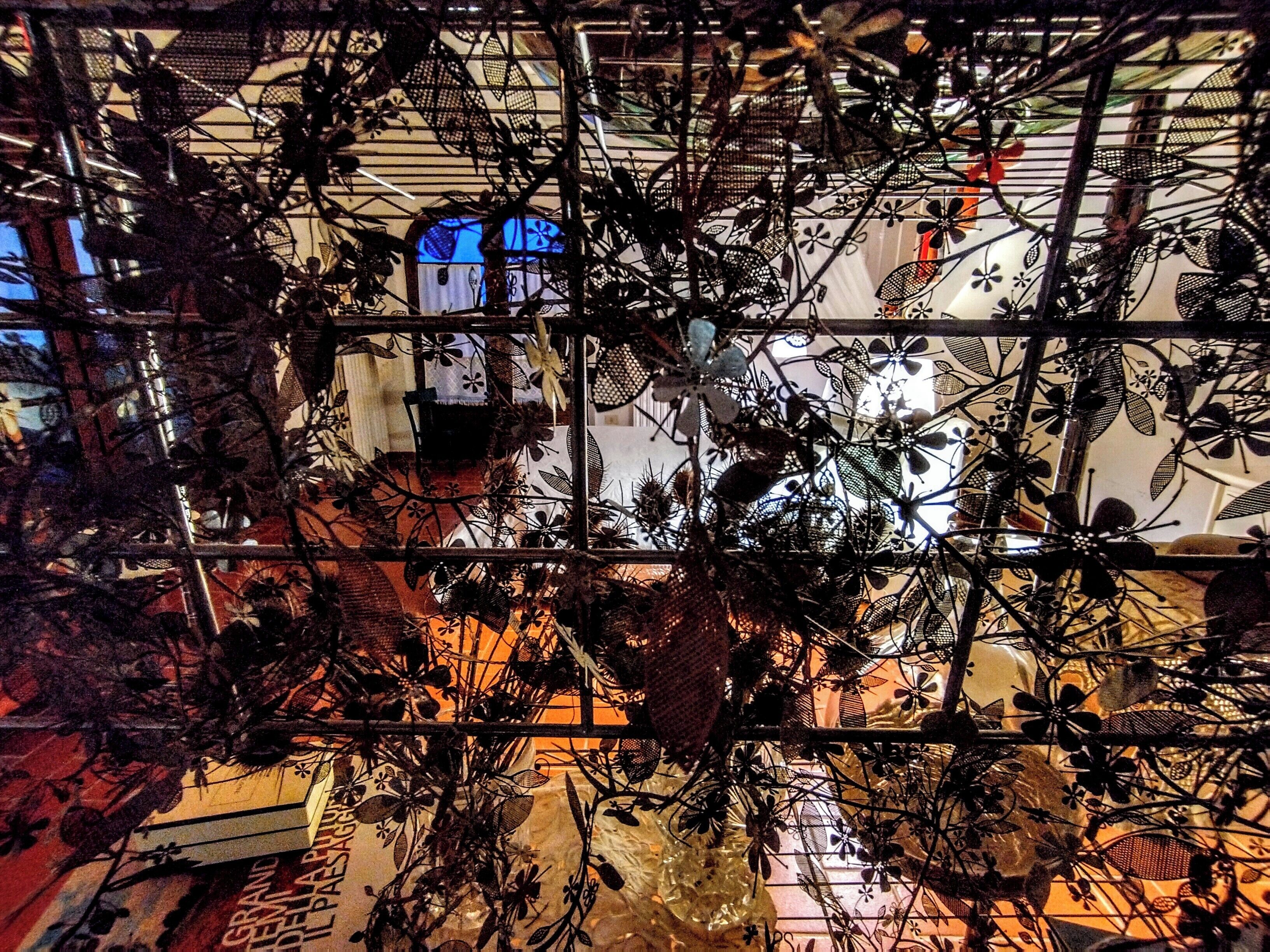 A complex metal structure with intricate designs, possibly part of an architectural feature or installation.