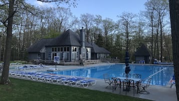 Relax by the serene pool surrounded by lush greenery and enjoy a tranquil atmosphere.
