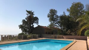A rectangular swimming pool with clear blue water, surrounded by a paved walkway. - Furnished 3 STARS Golf St Tropez RAYOL CANADEL Facing the SEA with POOL (Rayol-Canadel-sur-Mer)