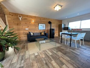 A modern living room with a sofa, coffee table, and a fireplace.