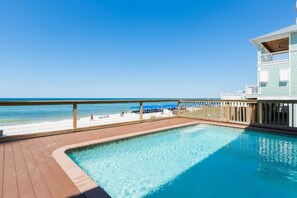 A pool area with a view of the beach and ocean. - Directly on the  Beach, 6 bedroom Beach House with Heated Pool and Hot tub. (Panama City Beach,)