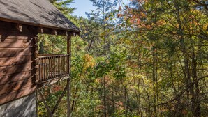 A wooden cabin with a balcony overlooking a forest. - Cozy, View, NFL Sunday, SuperFast WiFi, Arcade, Gated, Fishing & 2 Pools, Gated! (Sevierville,)