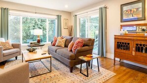 A living room with a sofa, coffee table, and a wooden cabinet.