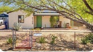 Uma casa térrea com porta verde e o número 4102 na parede.