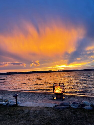 ON TORCH LAKE SANDY BEACH COTTAGE HOME! AMAZING SUNSETS! LARGE YARD JUST OPENED 