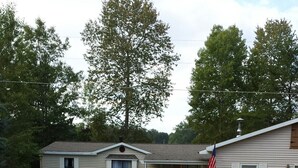 A two-story mobile home with a front yard and a gravel driveway. - Beautiful Sunsets, Trails, Wildlife and All Out of Doors to enjoy (Atlanta)
