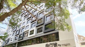A modern hotel building with a prominent sign for "GO HOTEL". - Icasa By GoGo Hotel (Taichung)