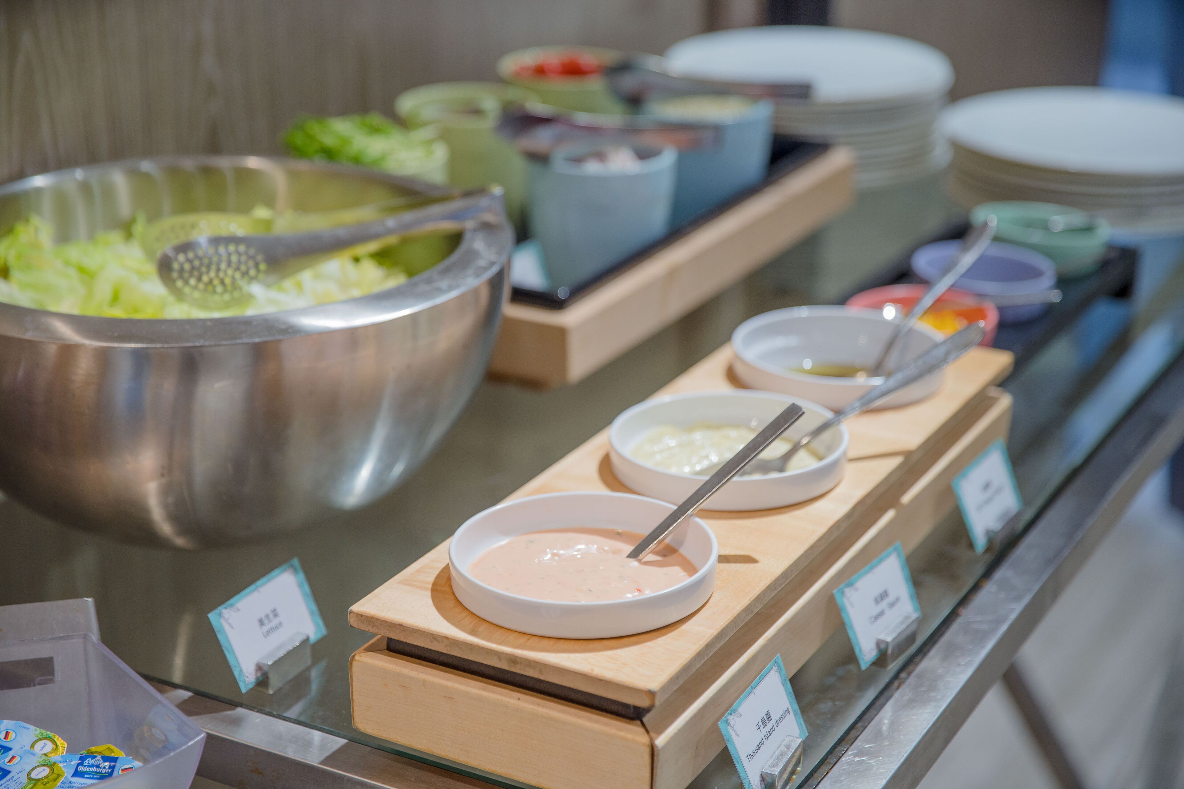 A buffet with various food items and serving utensils.