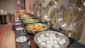 A buffet setup with various food items and utensils. - Icasa By GoGo Hotel (Taichung)