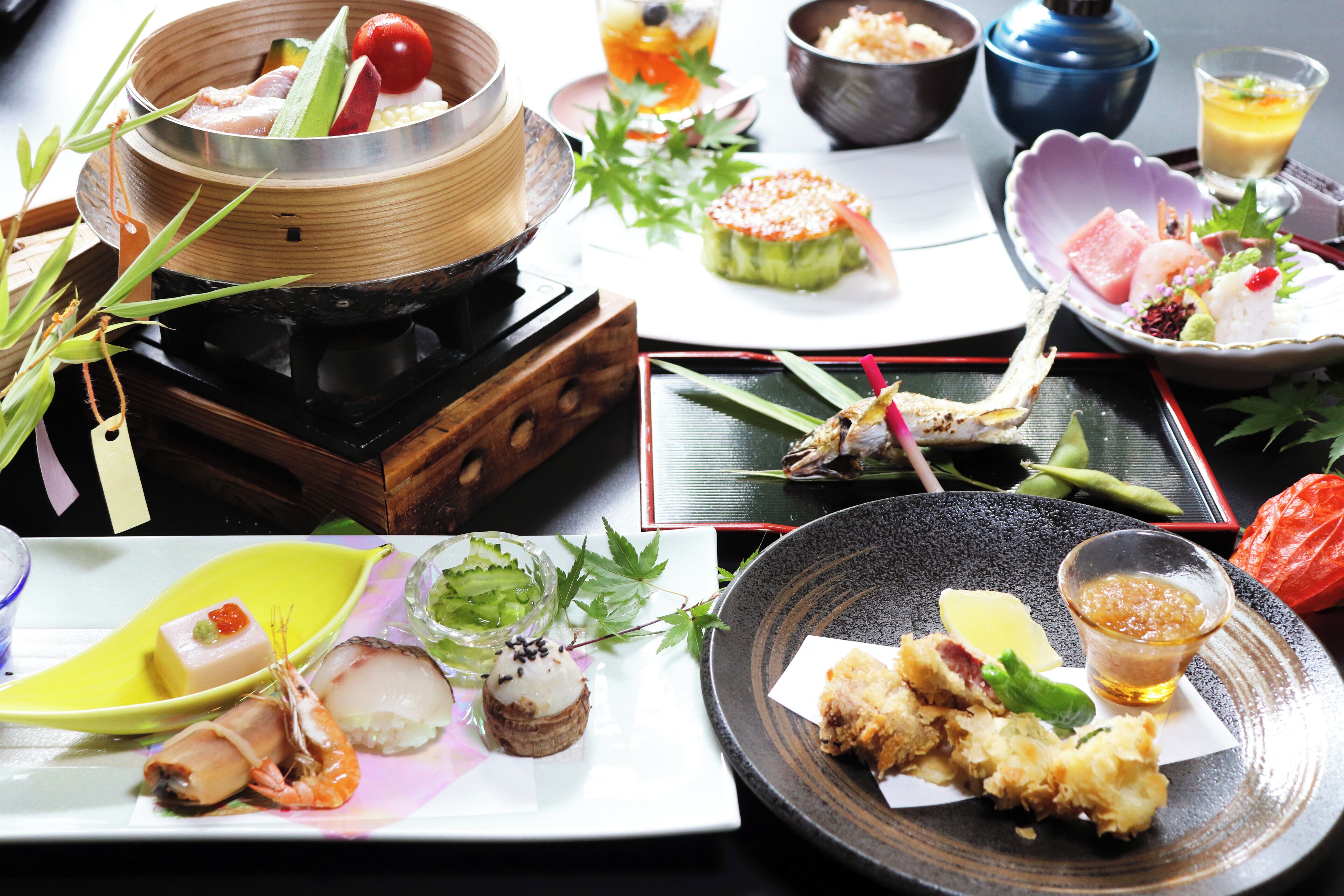 A variety of dishes on a table, including seafood, vegetables, and a hot pot.