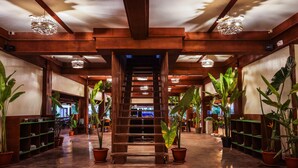 A wooden staircase in a hallway with potted plants on either side. - Retreat Siargao Resort (General Luna)