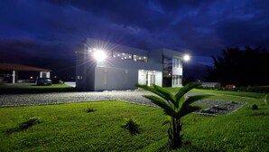 A modern building with a well-maintained lawn and a small garden area. - Unforgettable vacations, beautiful farm with astonishing and mountains view (Circasia)