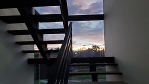 A modern staircase with a glass panel at the top, leading to a lower level. - Unforgettable vacations, beautiful farm with astonishing and mountains view (Circasia)