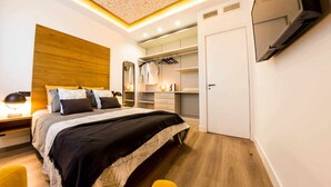 A modern bedroom with a bed, bedside table, wardrobe, and built-in TV. - Zabella Salamero - Spectacular penthouse in the center of town (Zaragoza)