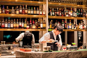 A bar with shelves stocked with various liquor bottles. - Hotel Indigo Shanghai Jing'An by IHG (Shanghai)
