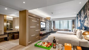 A modern hotel room with a large bed, a desk, a television, and a breakfast tray. - Hotel Indigo Shanghai Jing'An by IHG (Shanghai)