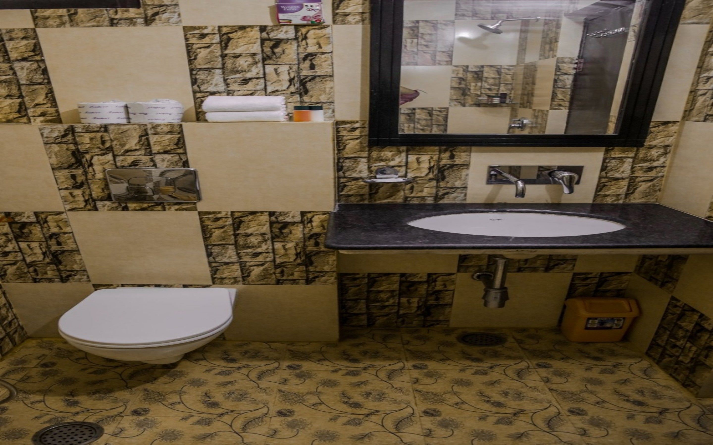 Een kleine badkamer met toilet, wastafel en spiegel.