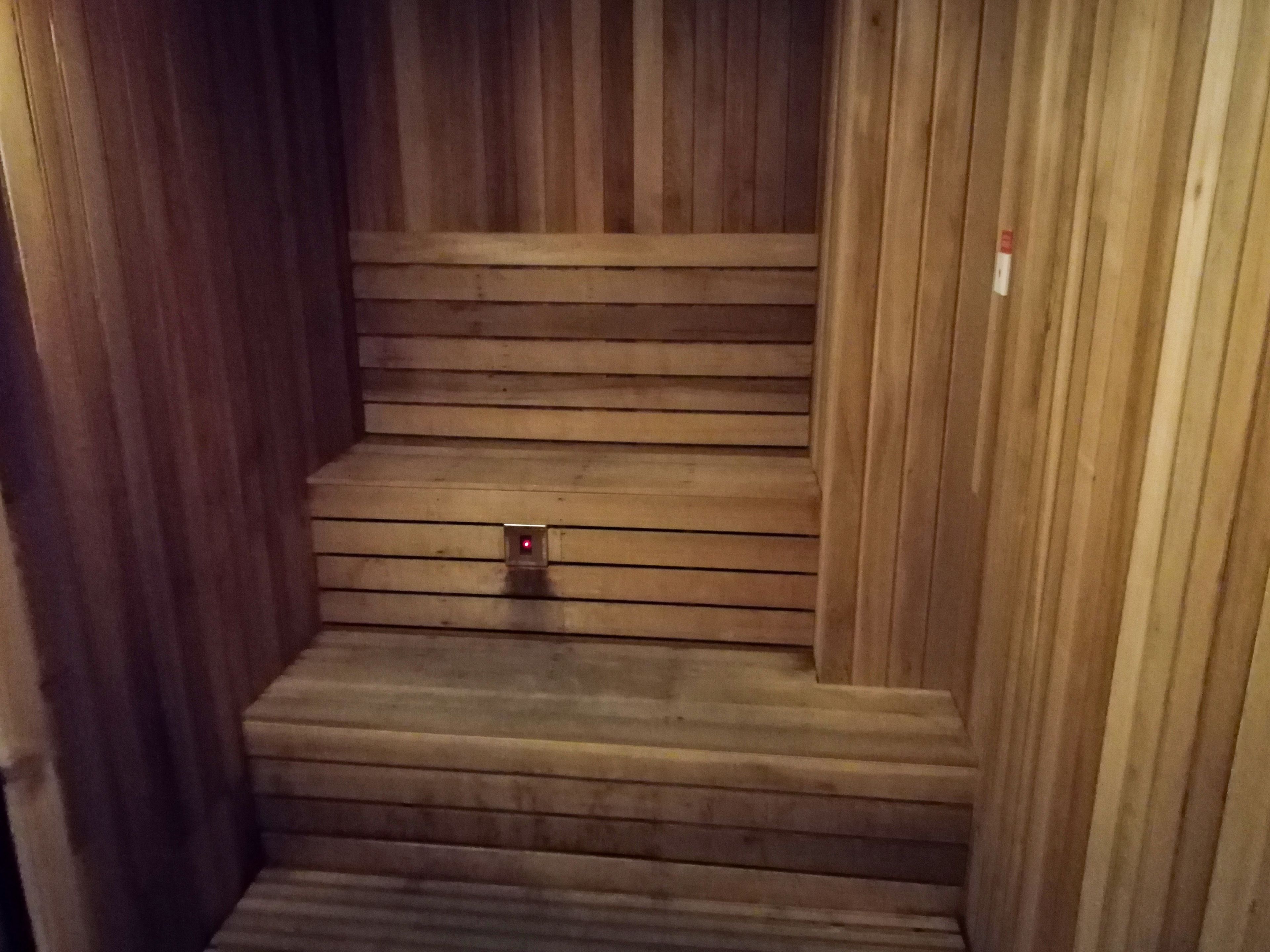 A wooden staircase with a red light at the bottom.