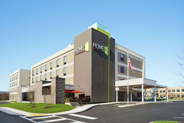 A modern hotel building with a sign reading "HOME 2 Suites by Hilton" and an American flag. - Home2 Suites by Hilton Warminster Horsham (Warminster)