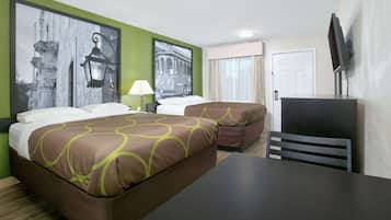 A hotel room with two beds, a desk, a chair, a TV, and artwork on the walls.