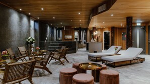 A modern lobby with wooden flooring, seating areas, and a reception desk. - Haga Slott (Enkoping)