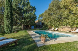 Relax by the pool surrounded by mature trees and a well-maintained lawn.