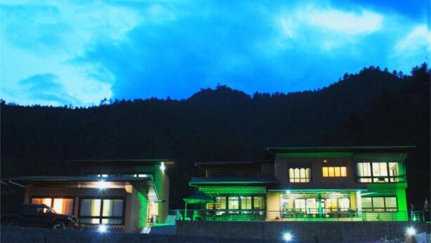 A modern two-story building with large windows and a flat roof, situated in a hilly area. - Soenam Tsokhang Resort (Paro)