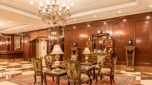 A formal dining area with a chandelier, wooden paneling, and classic furniture. - IP CITY HOTEL Osaka (Osaka)