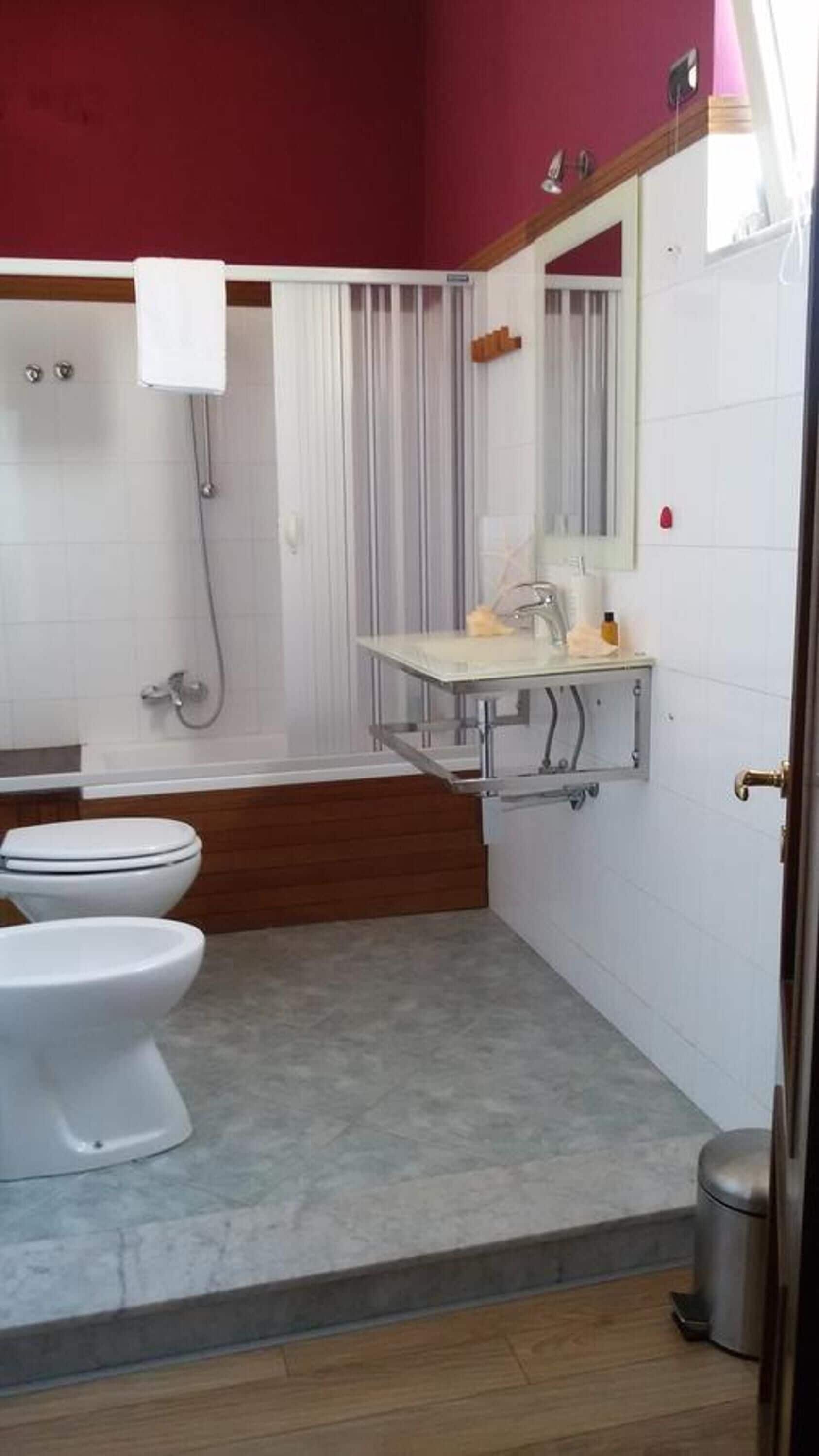 A bathroom with a toilet, a sink, and a shower.