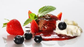A dessert with strawberries, blueberries, and whipped cream.
