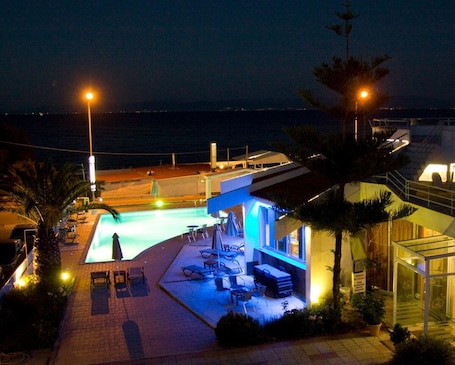Outdoor pool, pool loungers. Lasia Hotel