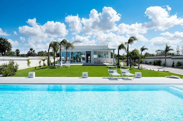 Enjoy a relaxing stay in this two-story home with a patio and lawn overlooking a swimming pool.