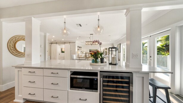 A spacious kitchen with a large island, built-in oven, and a dishwasher.