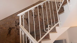 A staircase with white metal railings and stone steps. - Oleaclub Locazione Turistica (Maser)