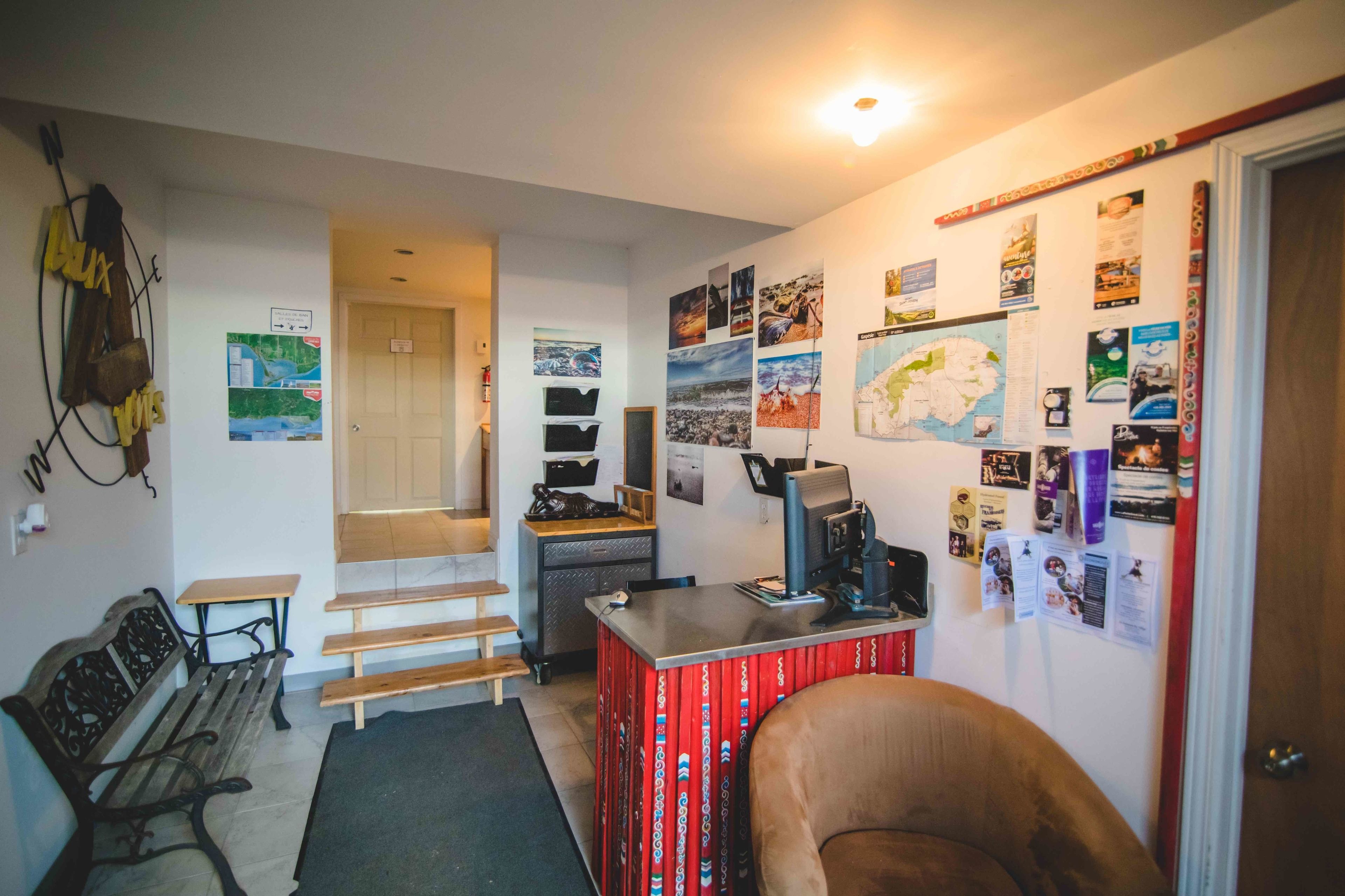 A compact living space with a desk, chair, and a small seating area.