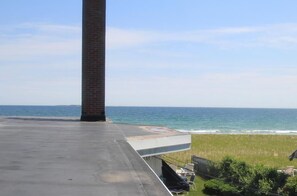 A rooftop terrace with a view of the ocean.